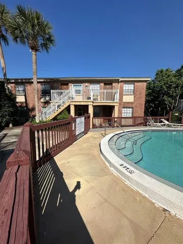 a view of a swimming pool with a patio