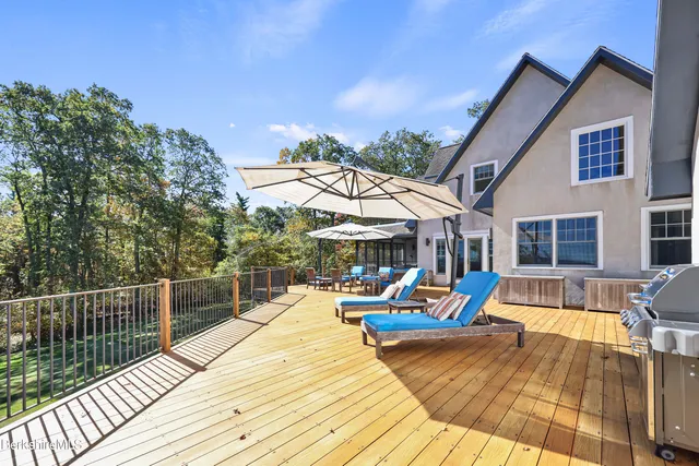 a dining room with wooden floor a chandelier a wooden table and chairs