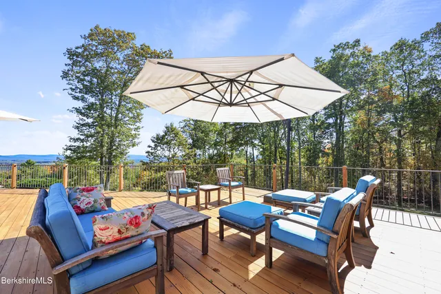 a dining area with stainless steel appliances kitchen island granite countertop a dining table and chairs with wooden floor