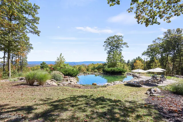 a kitchen with kitchen island granite countertop a stove and a sink