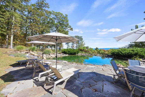 a large kitchen with stainless steel appliances granite countertop a large stove and cabinets