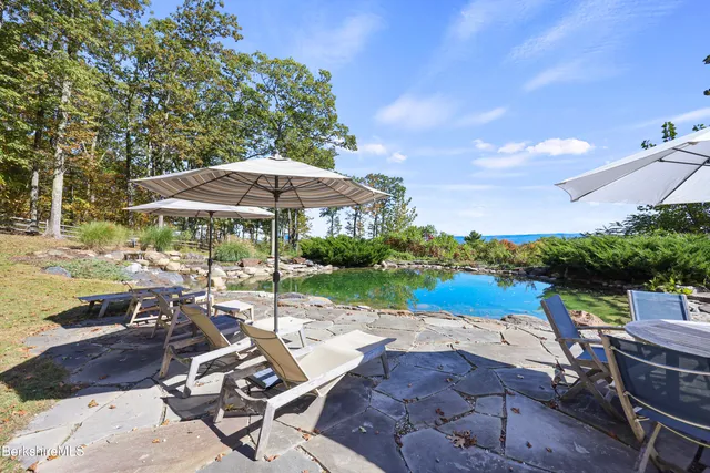 a large kitchen with stainless steel appliances granite countertop a large stove and cabinets