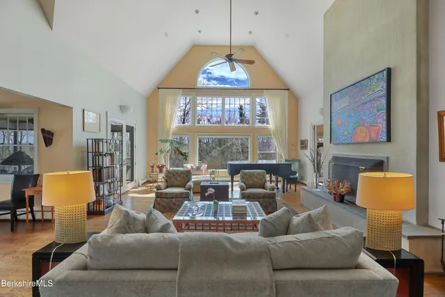 a living room with furniture a window and gym equipment