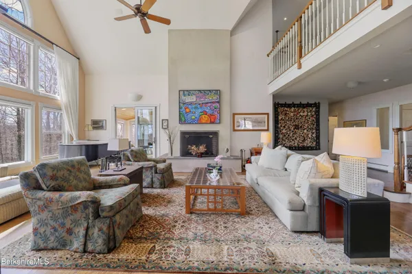 a living room with furniture a piano and a flat screen tv