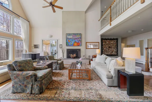 a living room with furniture a piano and a flat screen tv