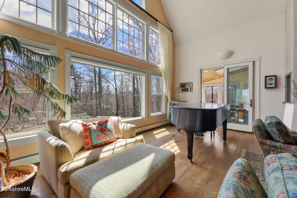 a bedroom with furniture and large windows