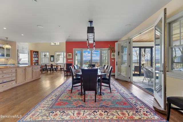 a bedroom with a bed furniture and painting on the wall