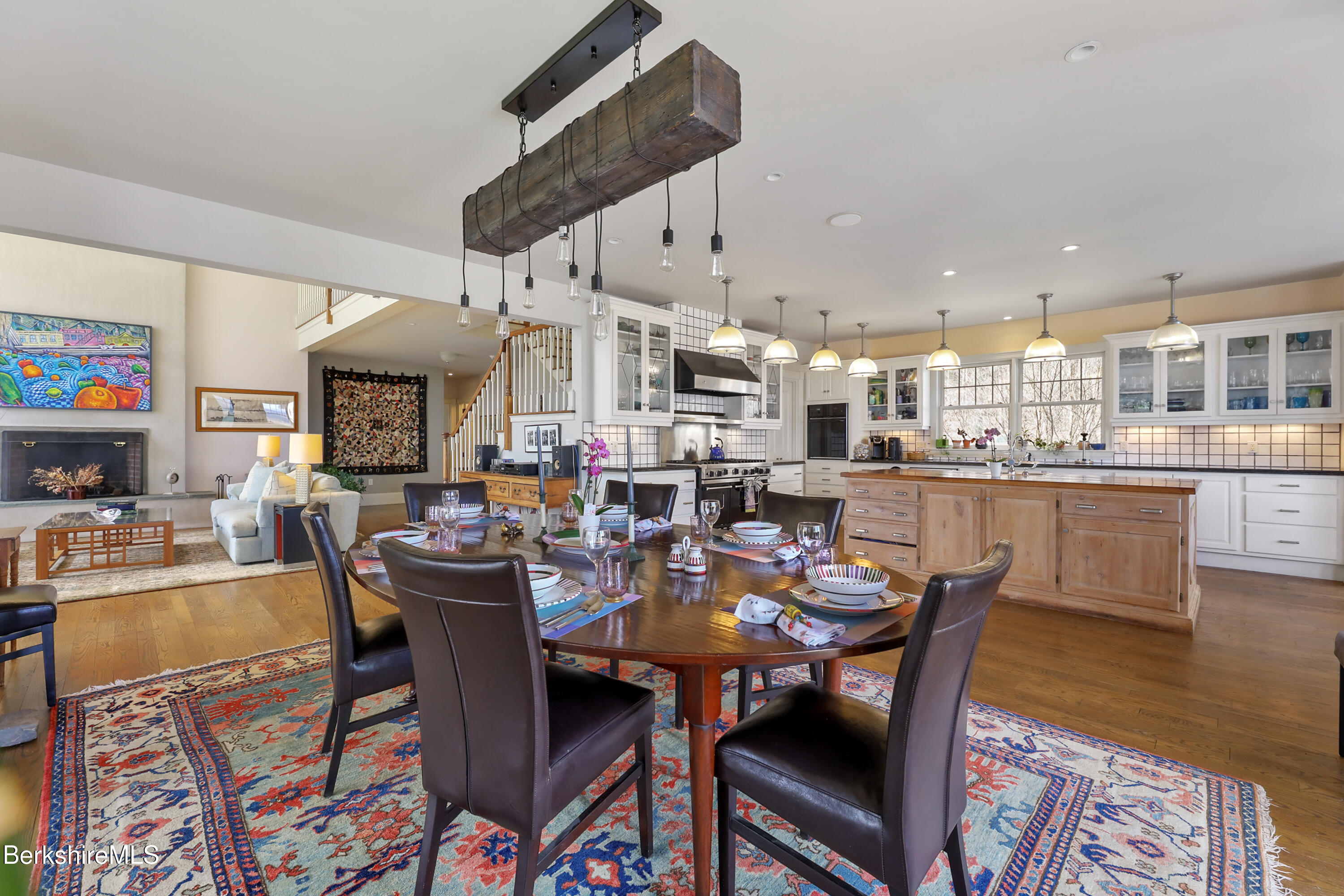 36 Millard Road Egremont, MA 01230 - Photo 41 of 93 a dining area with stainless steel appliances kitchen island granite countertop a dining table and chairs with wooden floor