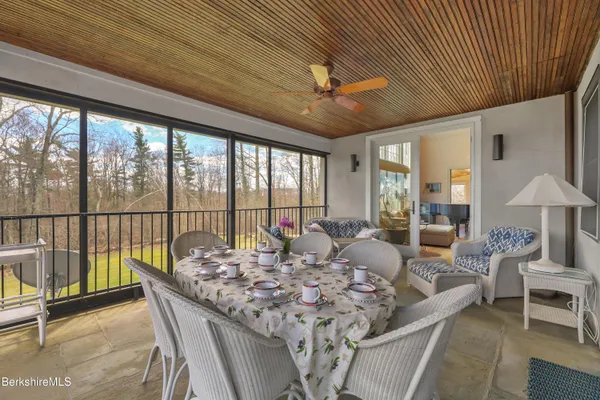 a spacious bedroom with a bed and ceiling fan