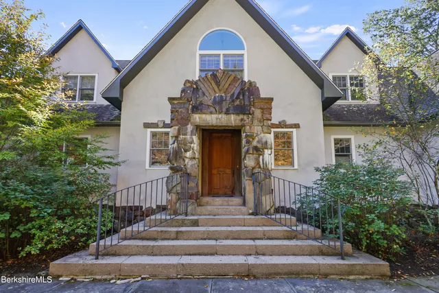 an aerial view of a house with swimming pool and sitting space