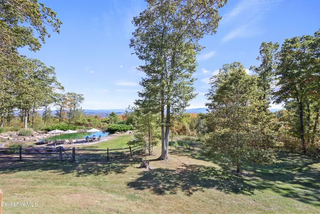 a aerial view of a white house with a yard and sitting space