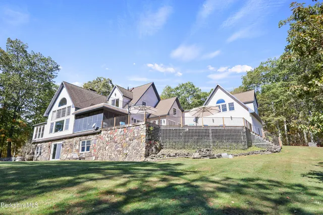 a view of backyard with outdoor seating and trees