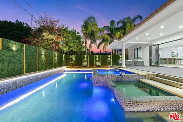 a view of swimming pool with a patio
