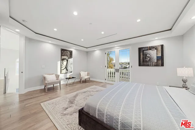 a spacious bedroom with a bed a table and chair