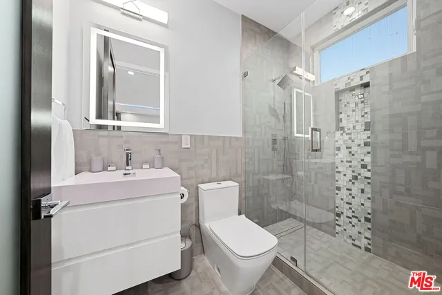 a bathroom with a toilet sink and shower