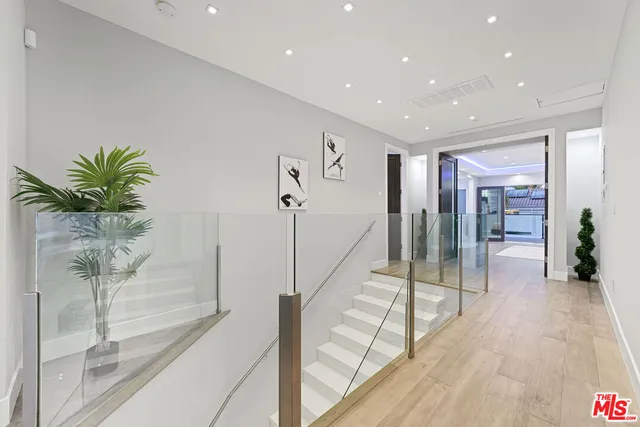 a view of hallway with chandelier and glass door