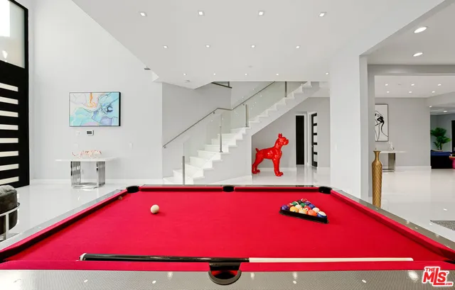 a very nice looking room with a floor to ceiling window and pool table