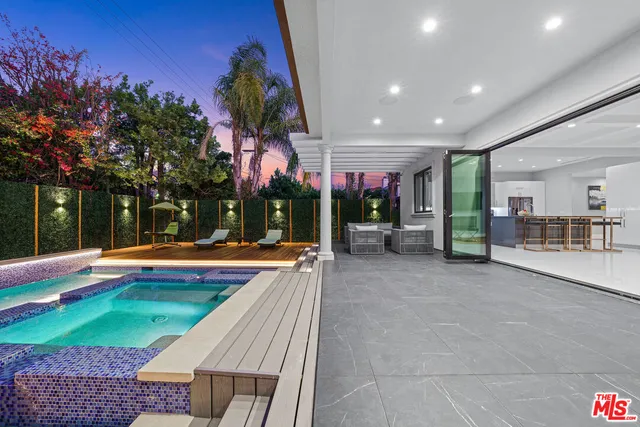 a view of a house with swimming pool and sitting area
