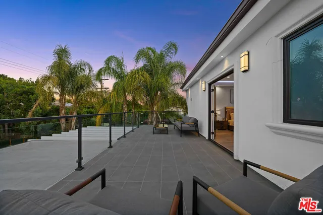 a view of a street with potted plants