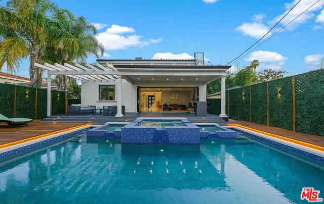 a view of swimming pool with chairs and tables
