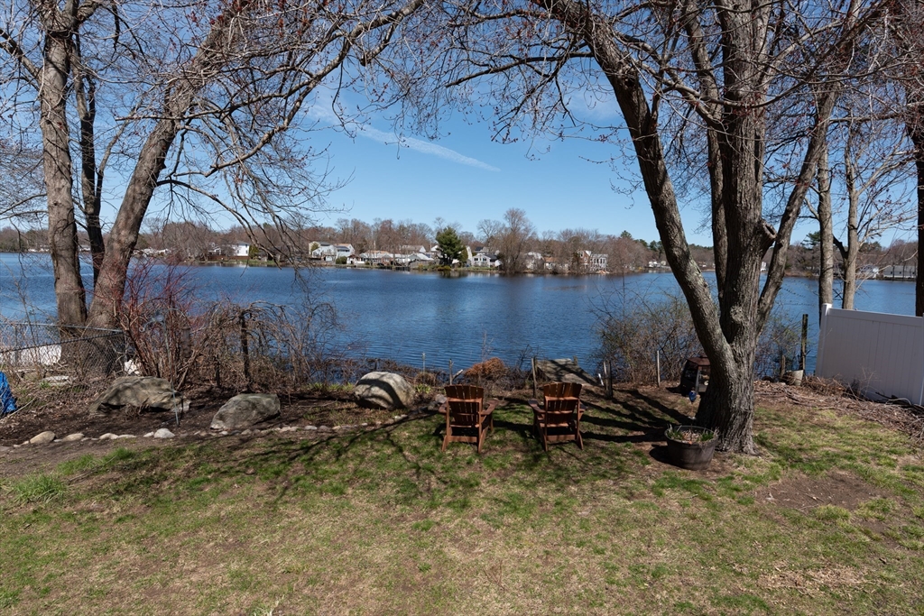 46 West Shore Road Holbrook, MA 02343 - Photo 33 of 33 a view of a backyard with table and chairs and a large tree