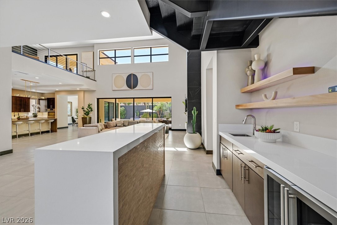 53 Garibaldi Way Henderson, NV 89011 - Photo 79 of 80 Kitchen with beverage cooler, open shelves, a center island, recessed lighting, and open floor plan