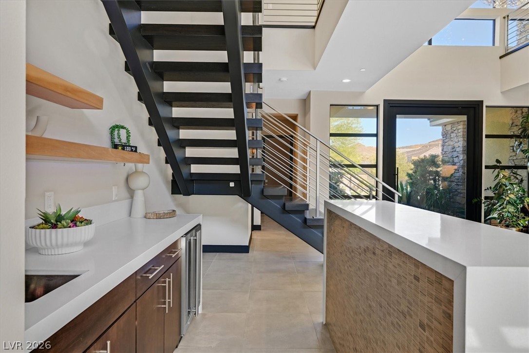 53 Garibaldi Way Henderson, NV 89011 - Photo 15 of 80 Stairs with plenty of natural light, beverage cooler, recessed lighting, and tile patterned flooring