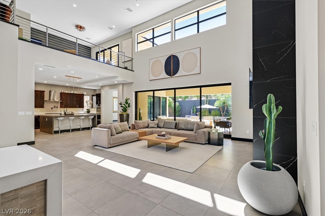 53 Garibaldi Way Henderson, NV 89011 - Photo 16 of 80 Living area featuring tile patterned floors, recessed lighting, and a towering ceiling