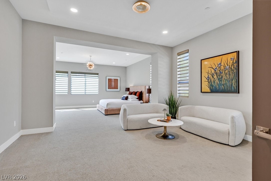 53 Garibaldi Way Henderson, NV 89011 - Photo 26 of 80 Bedroom featuring multiple windows, light carpet, recessed lighting, and a chandelier