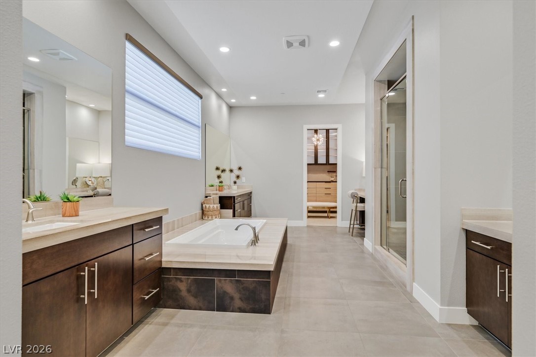 53 Garibaldi Way Henderson, NV 89011 - Photo 31 of 80 Full bath with two vanities, a bath, recessed lighting, a stall shower, and light tile patterned floors