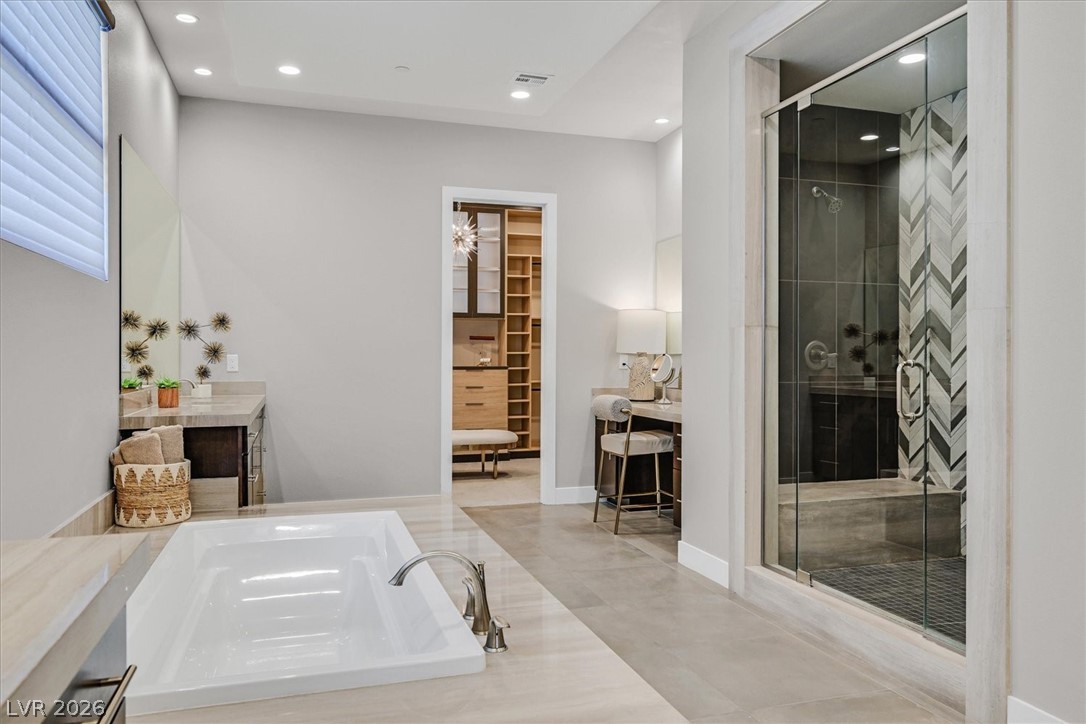 53 Garibaldi Way Henderson, NV 89011 - Photo 32 of 80 Bathroom featuring vanity, a walk in closet, a stall shower, a bath, and recessed lighting