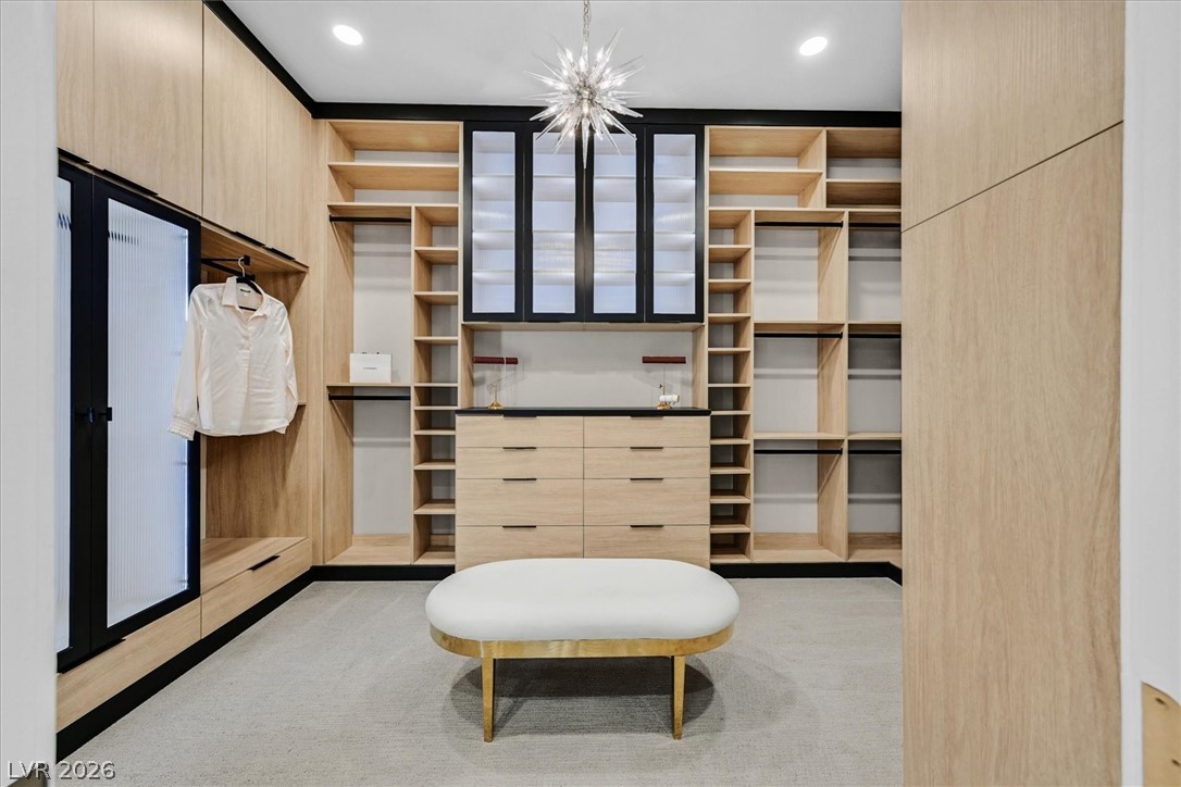 53 Garibaldi Way Henderson, NV 89011 - Photo 34 of 80 Walk in closet with light colored carpet and a chandelier