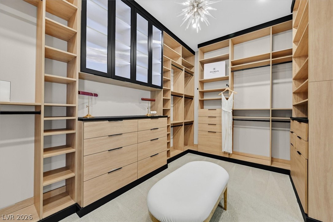 53 Garibaldi Way Henderson, NV 89011 - Photo 35 of 80 Walk in closet with light carpet and a chandelier