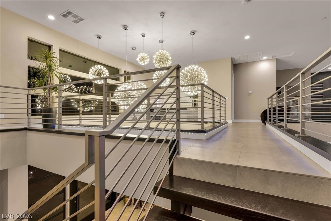 53 Garibaldi Way Henderson, NV 89011 - Photo 38 of 80 Stairway featuring recessed lighting and a chandelier