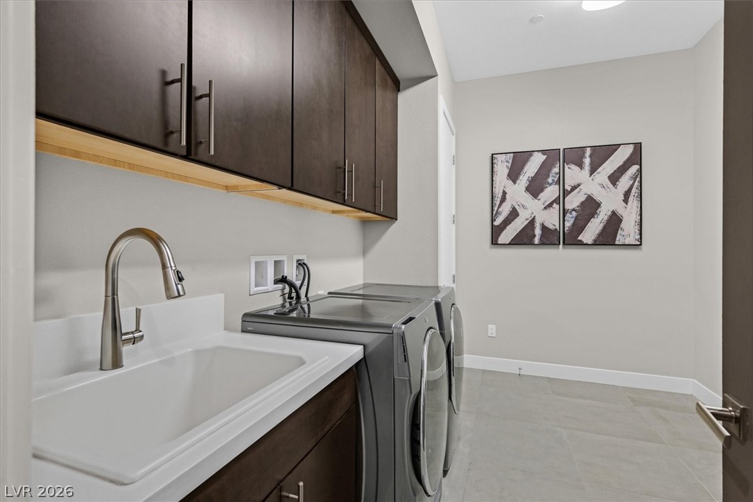 53 Garibaldi Way Henderson, NV 89011 - Photo 51 of 80 Washroom with cabinet space, washing machine and clothes dryer, and light tile patterned flooring