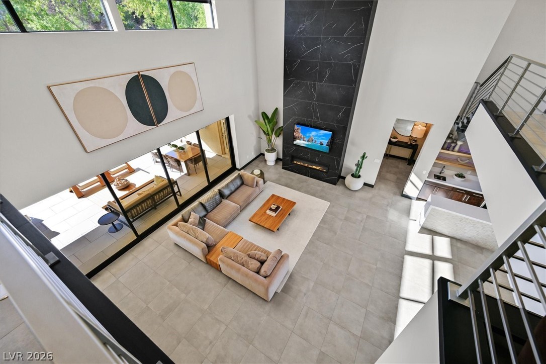 53 Garibaldi Way Henderson, NV 89011 - Photo 52 of 80 Tiled living area featuring a towering ceiling and stairs