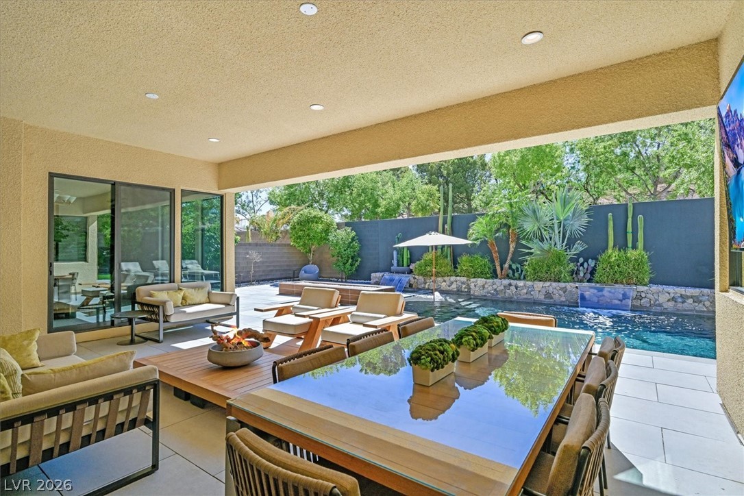 53 Garibaldi Way Henderson, NV 89011 - Photo 57 of 80 Fenced backyard with a patio, an outdoor living space, and outdoor dining space