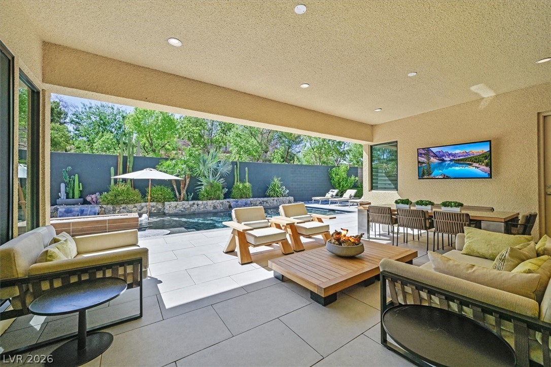53 Garibaldi Way Henderson, NV 89011 - Photo 58 of 80 Fenced backyard featuring an outdoor living space with a fire pit and a patio
