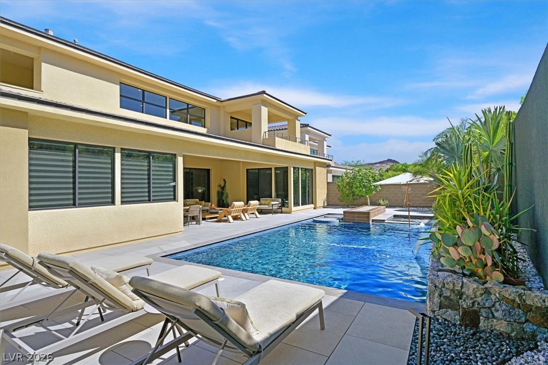 53 Garibaldi Way Henderson, NV 89011 - Photo 61 of 80 View of pool featuring a patio area, a balcony, outdoor lounge area, a fenced backyard, and a hot tub