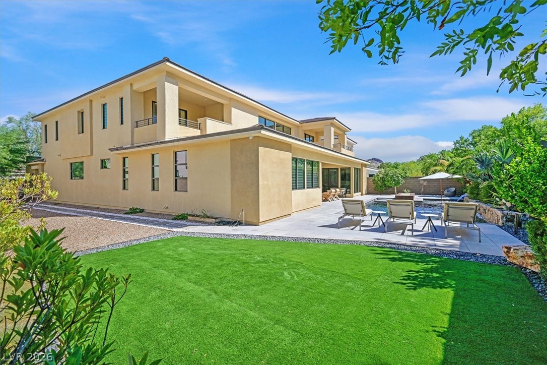 53 Garibaldi Way Henderson, NV 89011 - Photo 62 of 80 Rear view of property featuring a jacuzzi, stucco siding, a fenced backyard, and a patio