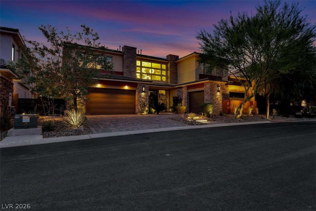 53 Garibaldi Way Henderson, NV 89011 - Photo 71 of 80 Modern home with stone siding, decorative driveway, an attached garage, and stucco siding