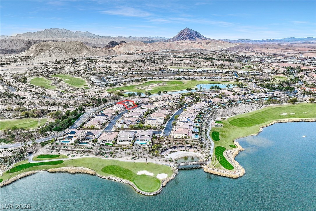 53 Garibaldi Way Henderson, NV 89011 - Photo 76 of 80 Aerial overview of property's location featuring a golf course, nearby suburban area, and a water and mountain view