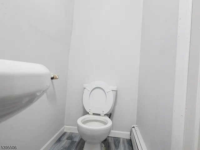 a bathroom with a toilet sink and a mirror
