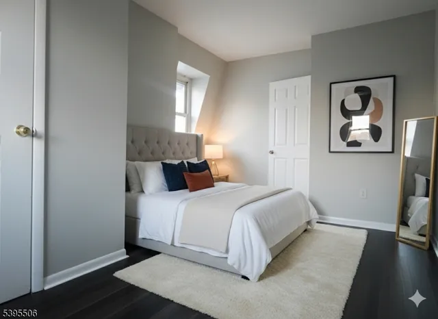 a bedroom with a bed and painting on the wall