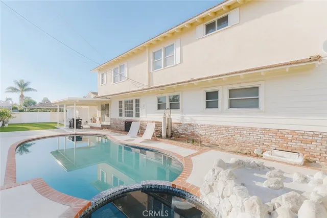 a living room with stainless steel appliances kitchen island granite countertop a sink and cabinets