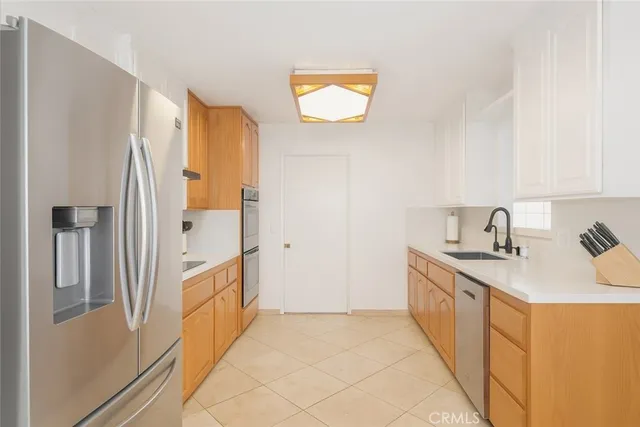 a kitchen with stainless steel appliances granite countertop a refrigerator and a sink