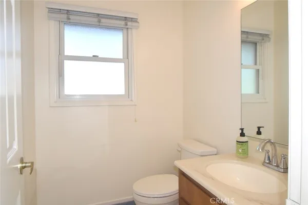 a white toilet sitting next to a bathroom sink