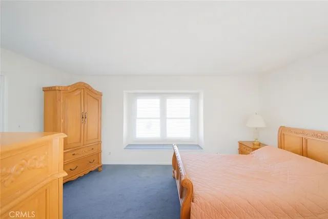 a bedroom with a bed and wooden cabinets