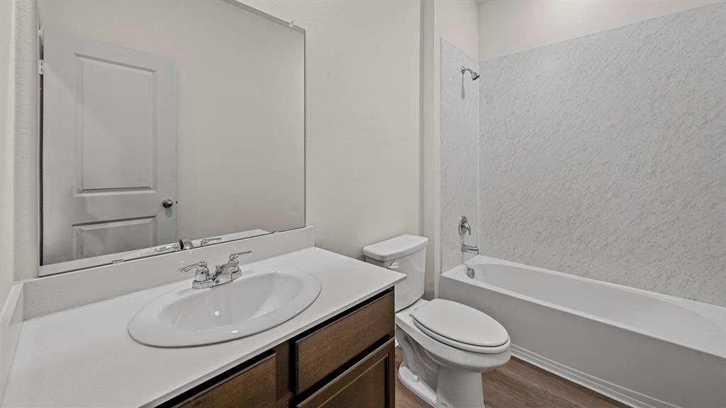 a bathroom with a sink toilet and a mirror