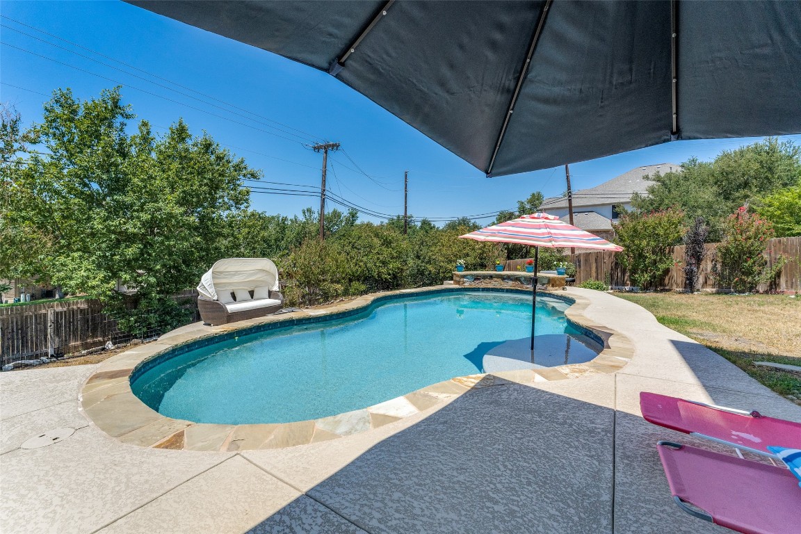 a view of a swimming pool with a patio